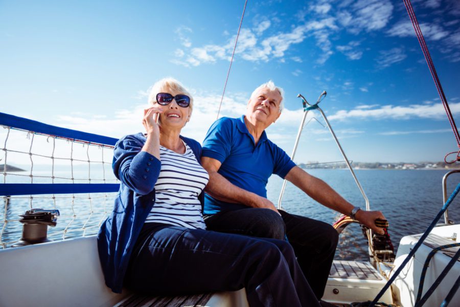 an elderly couple in a boat looking above