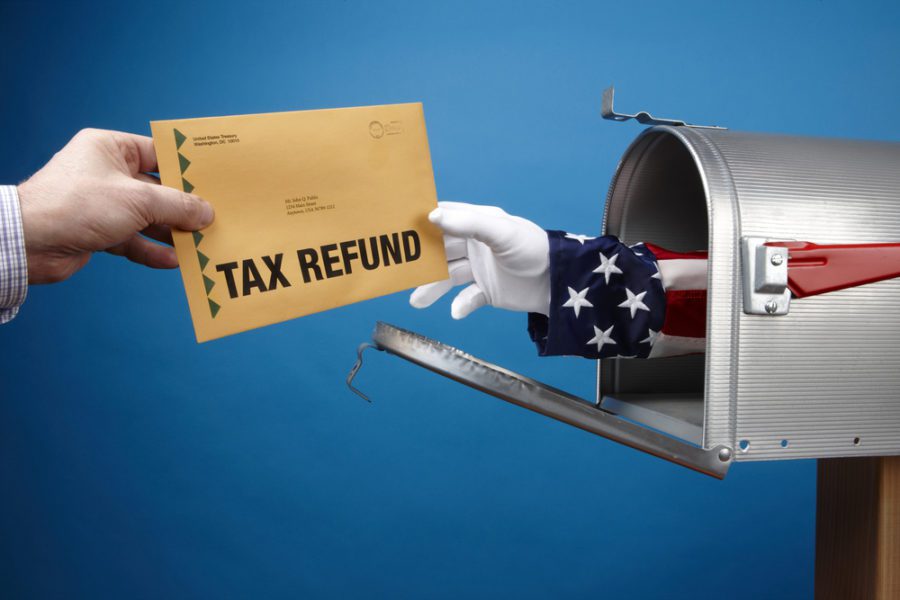 a hand transforming Tax Refund Envelop